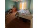 Bedroom features a single bed, dresser, and wood floors at 95 Heartwood Xing, Dallas, GA 30157