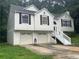 Traditional two-story home with a two-car garage, clean white exterior, and inviting front porch steps at 95 Heartwood Xing, Dallas, GA 30157