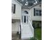 Close-up showcasing a home's front door, accessed by white stairs, with a decorative arched window above at 95 Heartwood Xing, Dallas, GA 30157