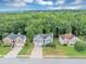A peaceful neighborhood showcases three homes, surrounded by trees and large lawns at 1735 Silver Way, Lithia Springs, GA 30122