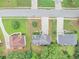 This aerial view shows three homes, their driveways, roofs, and surrounding lawns at 1735 Silver Way, Lithia Springs, GA 30122