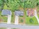 An aerial view of three houses shows well-maintained lawns and mature trees at 1735 Silver Way, Lithia Springs, GA 30122