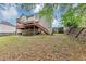 Backyard view of home with multilevel wooden deck and stairs at 1735 Silver Way, Lithia Springs, GA 30122