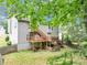 Backyard view of home with multilevel wooden deck and stairs at 1735 Silver Way, Lithia Springs, GA 30122