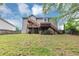 Backyard view of home with multilevel wooden deck and stairs at 1735 Silver Way, Lithia Springs, GA 30122