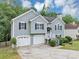 Attractive home with a two-car garage and lush greenery and a well-maintained front lawn at 1735 Silver Way, Lithia Springs, GA 30122
