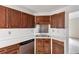 Close up shot of kitchen sink with white countertops and dark brown cabinets at 1735 Silver Way, Lithia Springs, GA 30122