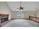 Large living room with vaulted ceiling, stone fireplace, and a ceiling fan with wooden blades at 1735 Silver Way, Lithia Springs, GA 30122