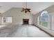 Spacious living room with vaulted ceilings, a stone fireplace, and large windows allowing natural light at 1735 Silver Way, Lithia Springs, GA 30122