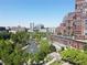 Aerial view showcases a landscaped community with a serene pond and nearby buildings in a park setting at 790 North Ne Ave # 209, Atlanta, GA 30306