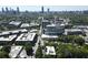 Expansive aerial view reveals the city skyline and surrounding residential area with lush green trees at 790 North Ne Ave # 209, Atlanta, GA 30306