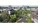 Aerial view captures urban landscape with buildings, green trees, and the city skyline in the distance at 790 North Ne Ave # 209, Atlanta, GA 30306
