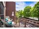 Cozy balcony with comfortable seating, decorative lighting, and a view of lush green trees and neighborhood at 790 North Ne Ave # 209, Atlanta, GA 30306