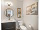 Modern bathroom featuring a grey vanity, contemporary round mirror and art at 790 North Ne Ave # 209, Atlanta, GA 30306
