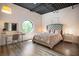 Bright bedroom with a unique circular window, modern vanity, and a plush, inviting bed at 790 North Ne Ave # 209, Atlanta, GA 30306