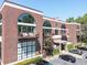 Brick apartment building featuring large arched windows, private balconies, and convenient parking at 790 North Ne Ave # 209, Atlanta, GA 30306