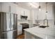 Modern kitchen featuring stainless steel appliances, white cabinets and a large island at 790 North Ne Ave # 209, Atlanta, GA 30306