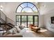 Bright living room featuring a large window, modern stairway, and comfortable seating at 790 North Ne Ave # 209, Atlanta, GA 30306