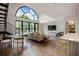 Bright living room featuring a modern sofa, elegant lighting, and an impressive arched window with views at 790 North Ne Ave # 209, Atlanta, GA 30306