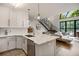 Modern kitchen with an open floor plan showcasing the stairway architecture and living area at 790 North Ne Ave # 209, Atlanta, GA 30306