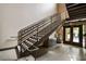Modern stairwell with sleek metal railings and well-lit tile flooring leading to the building entrance at 790 North Ne Ave # 209, Atlanta, GA 30306