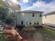 Backyard view showcasing a green exterior, patio, and partial lawn at 1601 Dosk Ave, Lawrenceville, GA 30044