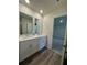 Bright bathroom with double vanity, modern fixtures, and stylish wood-look flooring at 1601 Dosk Ave, Lawrenceville, GA 30044