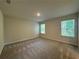 Spacious bedroom offers neutral paint, plush carpeting, and ample natural light at 1601 Dosk Ave, Lawrenceville, GA 30044