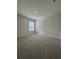 Comfortable bedroom featuring plush carpet, neutral paint, and a large window at 1601 Dosk Ave, Lawrenceville, GA 30044