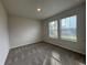 Bright bedroom with plush carpeting and abundant natural light from double windows at 1601 Dosk Ave, Lawrenceville, GA 30044