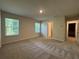 Large bedroom with carpet flooring, natural lighting, and an en-suite bathroom at 1601 Dosk Ave, Lawrenceville, GA 30044