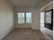 Cozy living room with hardwood flooring, a window, and an open door to the front porch at 1601 Dosk Ave, Lawrenceville, GA 30044