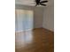 Bright bedroom with wood floor, ceiling fan and large window with vertical blinds at 1867 Myrtle Dr # 5, Atlanta, GA 30311