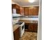 Kitchen features wood cabinets, white appliances, and tile backsplash at 1867 Myrtle Dr # 5, Atlanta, GA 30311