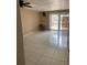 Open concept living room with tile floor, sliding glass doors, and ceiling fan at 1867 Myrtle Dr # 5, Atlanta, GA 30311