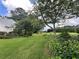 This home features a large green backyard with mature landscaping, a beautiful lawn, and views of nature at 333 Etoawha Vly, Woodstock, GA 30189