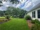 Beautiful backyard with lush green grass, trees, and charming landscaping at 333 Etoawha Vly, Woodstock, GA 30189