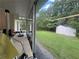 View from the sunroom to a well-kept lawn with a shed at 333 Etoawha Vly, Woodstock, GA 30189