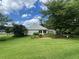 Spacious backyard view showcasing a well-maintained lawn, mature trees, and the home's exterior at 333 Etoawha Vly, Woodstock, GA 30189