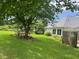 Lush backyard featuring mature trees, a small table with chairs and ample greenspace at 333 Etoawha Vly, Woodstock, GA 30189