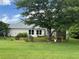 Well-maintained backyard with a charming seating area beneath a large shade tree at 333 Etoawha Vly, Woodstock, GA 30189