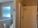 Bathroom with shower and frosted window for natural light and privacy at 333 Etoawha Vly, Woodstock, GA 30189