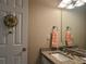 Bathroom featuring a granite countertop vanity, a towel rack, and a decorative wreath on the door at 333 Etoawha Vly, Woodstock, GA 30189