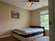 Bedroom with neutral walls, a ceiling fan, and a bright window providing natural light, creating a cozy atmosphere at 333 Etoawha Vly, Woodstock, GA 30189