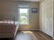 Bedroom with wood floors, a window offering a view of the outdoors, and a closet for storage at 333 Etoawha Vly, Woodstock, GA 30189