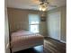 Bedroom featuring wood floors, double closets, and a window that provides natural light, plus a ceiling fan at 333 Etoawha Vly, Woodstock, GA 30189