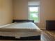Bedroom featuring a neutral color palette and a window that offers a view of the outdoors, plus a nightstand at 333 Etoawha Vly, Woodstock, GA 30189