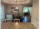 View of dining area with a table, chairs, and granite countertops at 333 Etoawha Vly, Woodstock, GA 30189