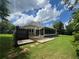 Back exterior view with screened-in patio and a walkway amidst the lawn at 333 Etoawha Vly, Woodstock, GA 30189