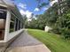 Exterior view featuring a sunroom with ample windows, a sprawling lawn, and shed at 333 Etoawha Vly, Woodstock, GA 30189